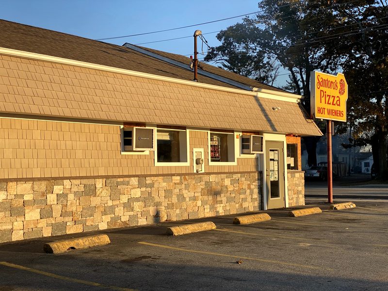 Santoro's Pizza storefront on Tiogue Avenue at golden hour.
