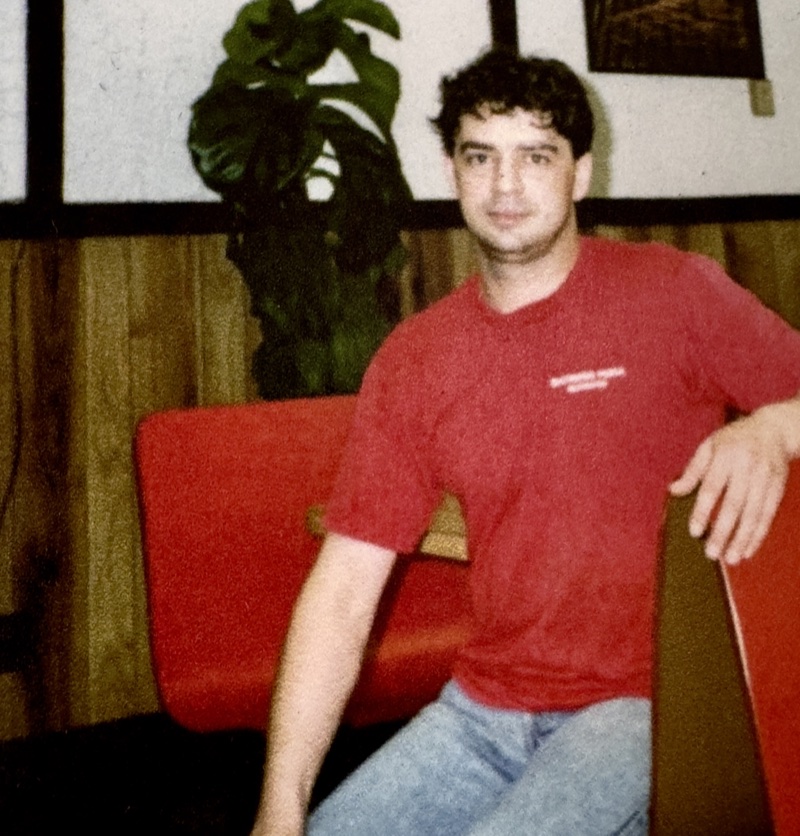 Ioannis &lsquo;John&rsquo; Labrakis sits in a booth inside Santoro&rsquo;s Pizza, Coventry, Rhode Island, in the late 1980s. He wears a red Santoro&rsquo;s t-shirt.